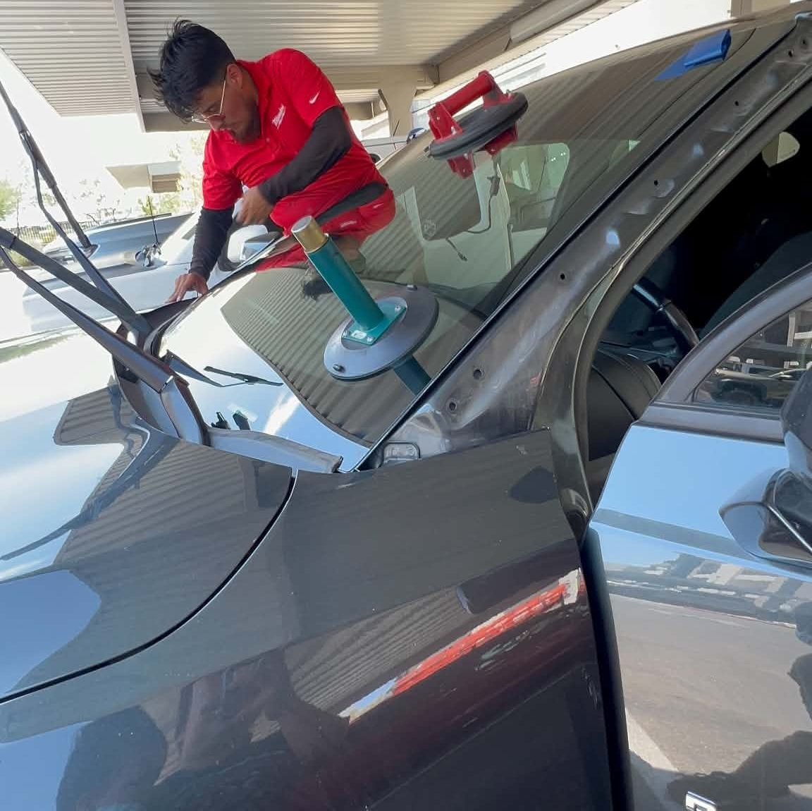 Technician setting suction cups before glass removal