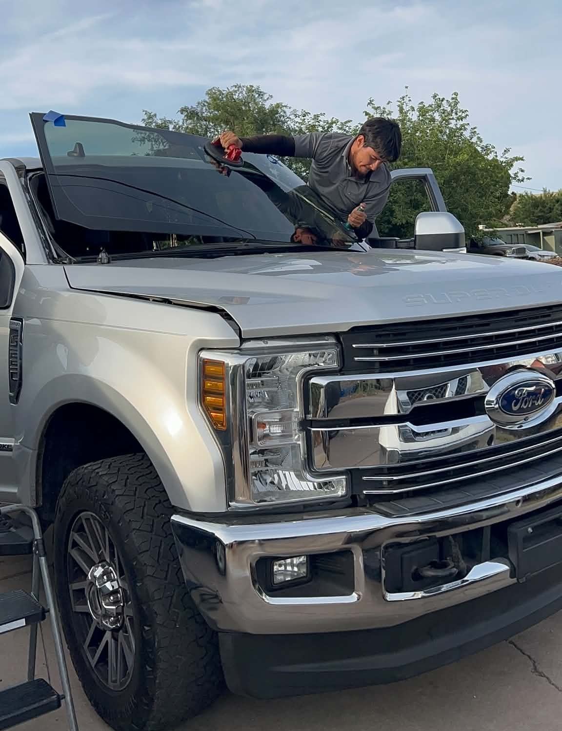 Za's Auto Glass technician installing a windshield on a Ford Super Duty truck